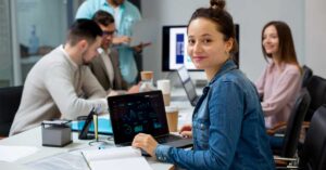 A picture showing a tech team sitting and working in an office environment.