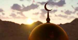 Picture depicting a mosque dome with a crescent tip, and sunset in the background.