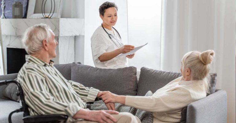 A female doctor giving consultation to an elderly couple at their home