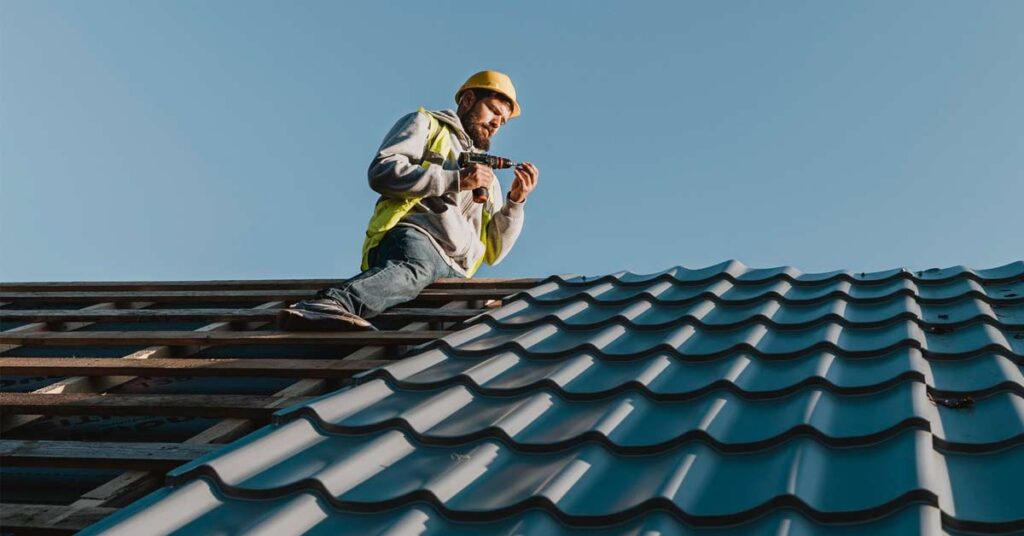 A repairman working on a house roof and doing repairing work