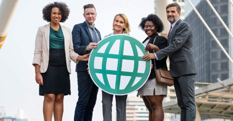 A group of multi-ethnic business people holding a web icon card board