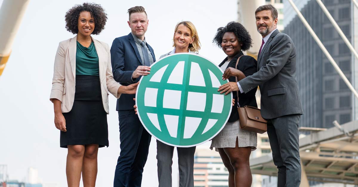 A group of multi-ethnic business people holding a web icon card board