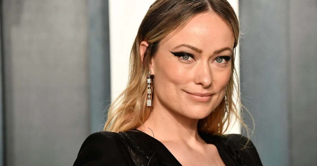 A picture of actress Olivia Wilde facing the camera, wearing a black dress