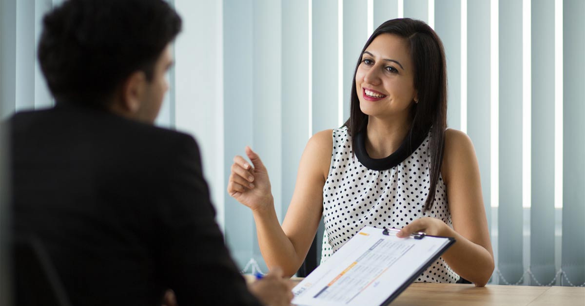 A female employer interviewing a male candidate for a job