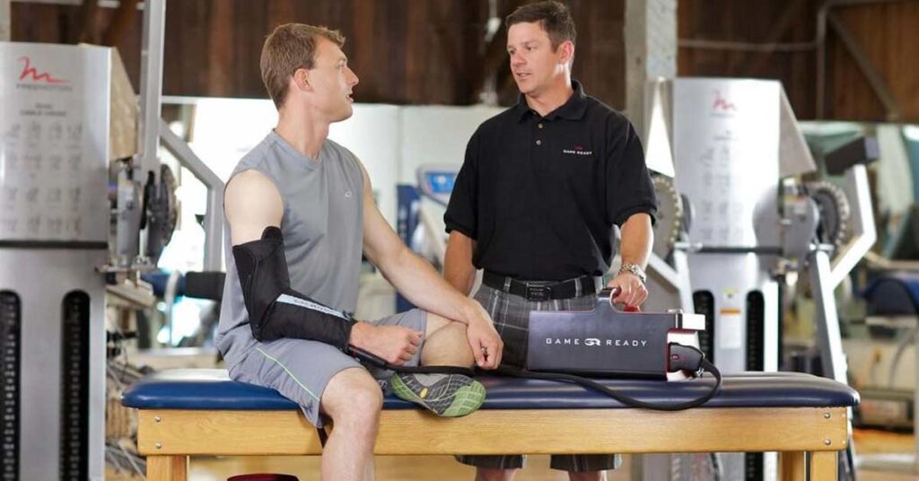 Two men in a gym using the Game Ready ice machine