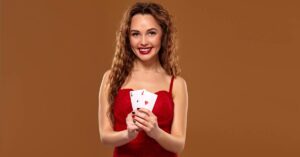 A beautiful woman in red dress holding playing cards