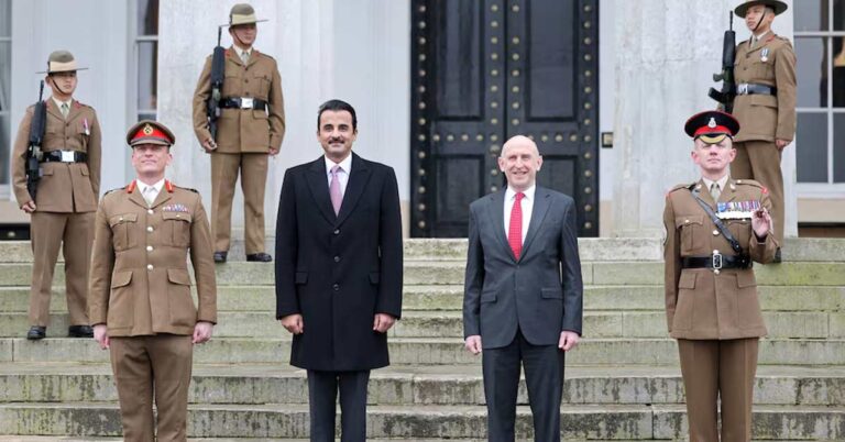 Qatar's Sheikh Tamim bin Hamad Al Thani and UK's Secretary of State for Defence John Healey pose with military personnel at the Royal Military Academy Sandhurst