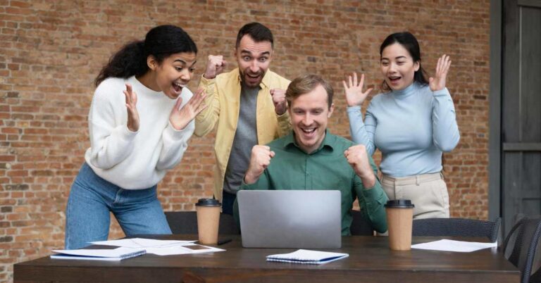 A happy multi-cultural team in an office setting.