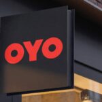 An OYO hoarding in front of a hotel gate.