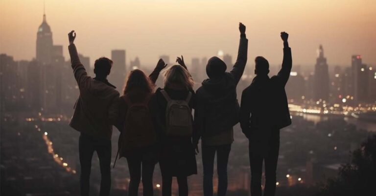 A team of five people photographed from the backside in an urban setting .