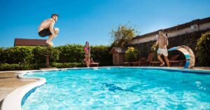 People enjoying in an inground pool