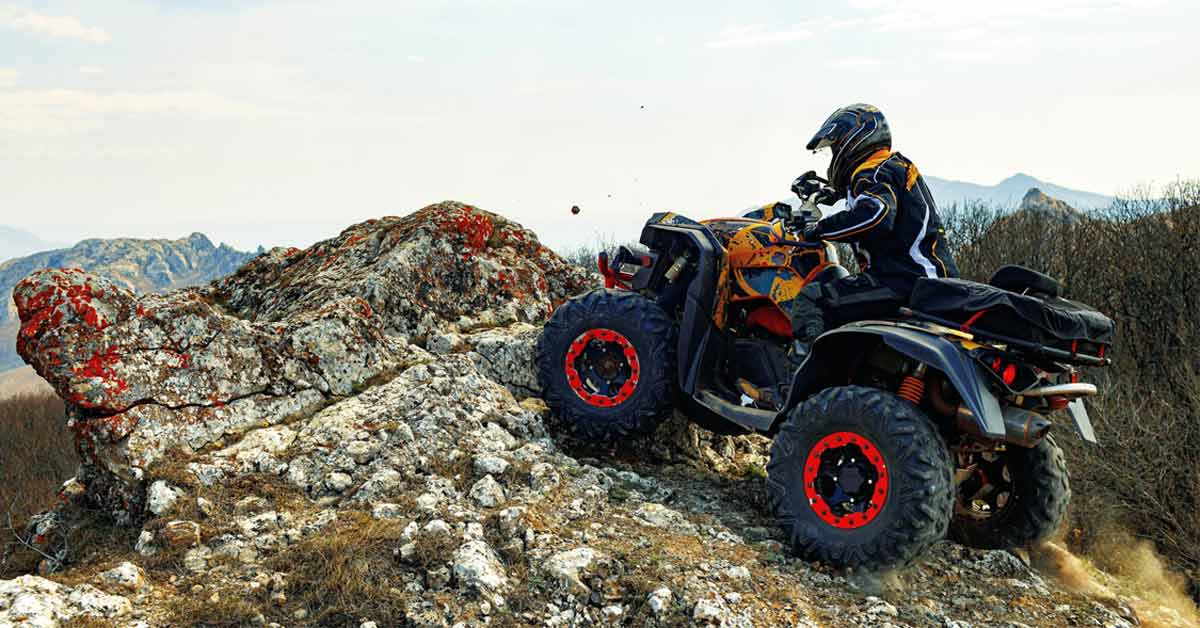 A rider touring in a UTV in the mountains somewhere.