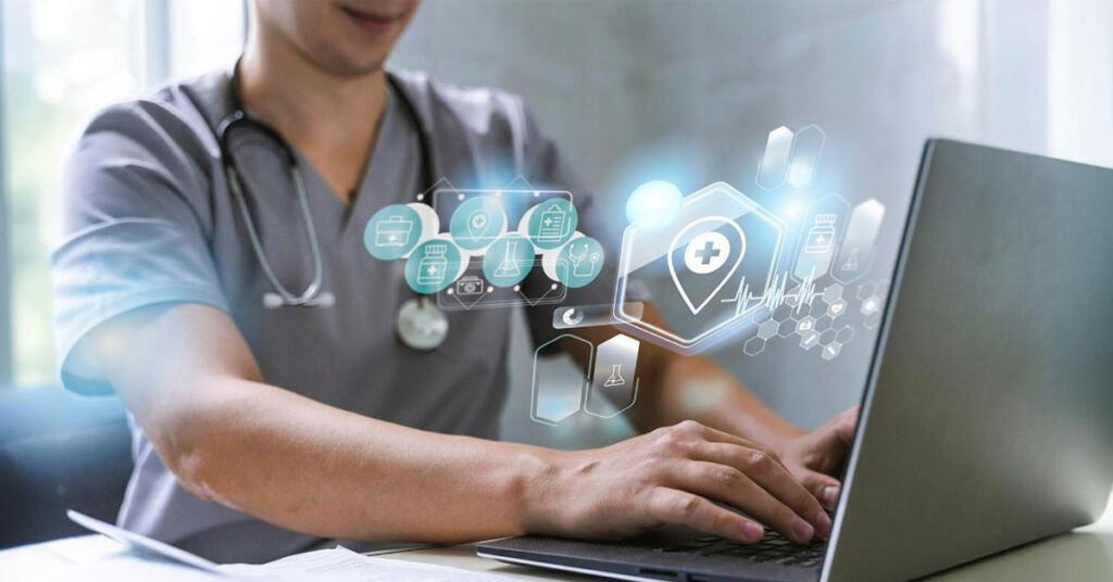 A picture depicting EHR system (a male doctor working on a laptop)