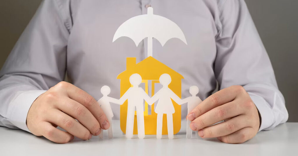paper-made family with umbrella - illustrating term insurance concept.