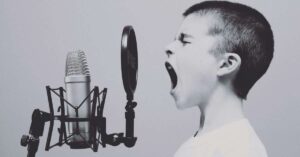 A young boy shouting on a mic - depicting an online venting chat concept