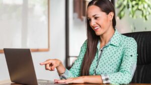 A happy young businesswoman working on a laptop - depicting a digital marketing concept