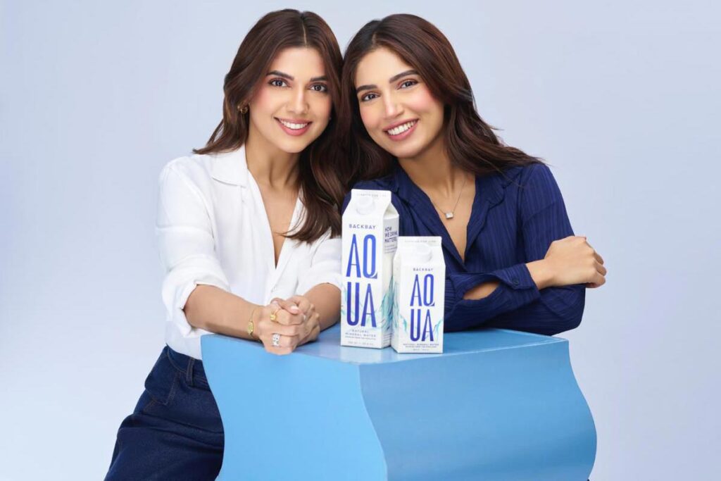 Bhumi Pednekar and Samiksha Pednekar together with Backbay Aqua cartons, showcasing sustainable packaging in a promotional setting.