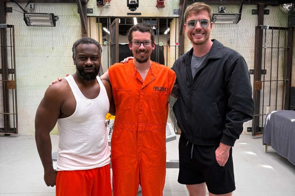 Lenny the cop, Ian the criminal, and MrBeast pictured together during the $500,000 Cop vs Criminal 100 Days Prison Challenge