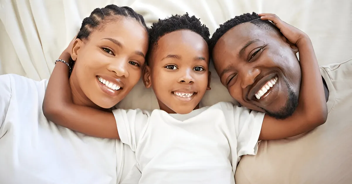 Smiling parents with their child embracing, symbolizing adaptable childcare and supportive parenting