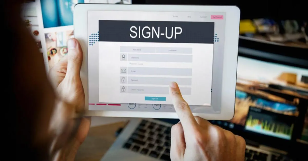 A woman filling a signup form on a tablet device.