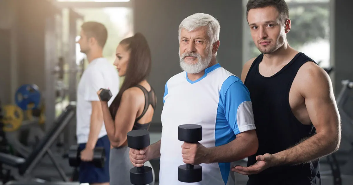 A group of people of different ages and gender in a fitness center or gym setting.