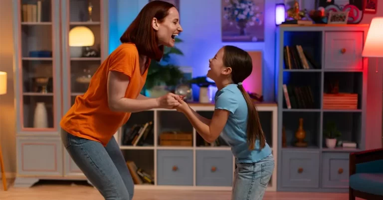 A young mother and daughter playing happily in a mildly lit room during a power cut.