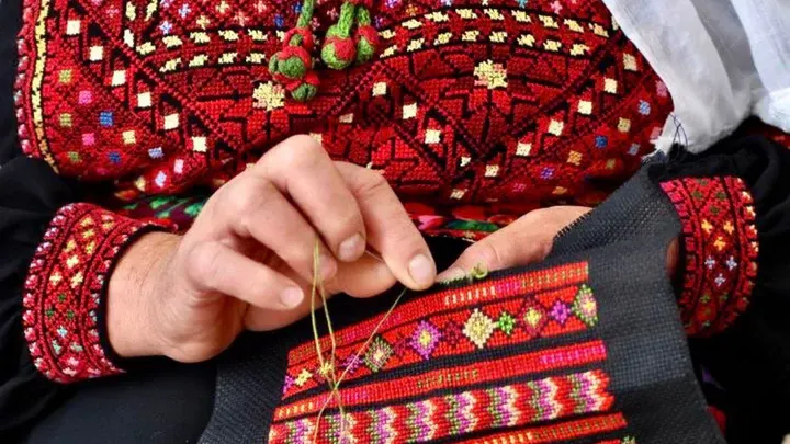 Close-up of traditional Palestinian tatreez embroidery, symbolizing heritage and storytelling through thread.