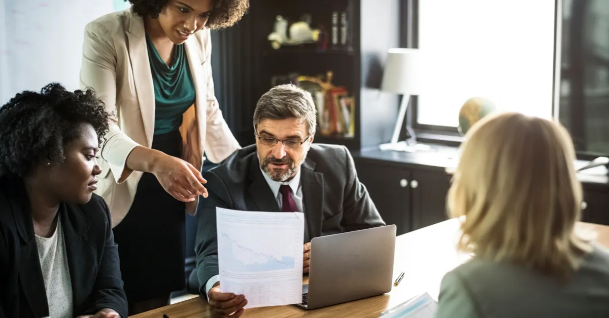A group of employees in a business meeting, representing workplace collaboration and understanding employee rights.