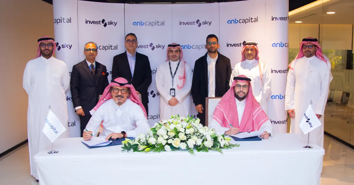 Representatives of InvestSky and anb Capital signing partnership agreement for Saudi market expansion.