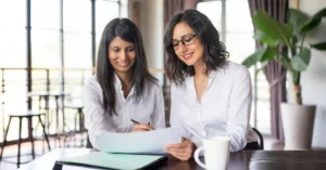 Startup founders signing company registration documents during business consultation