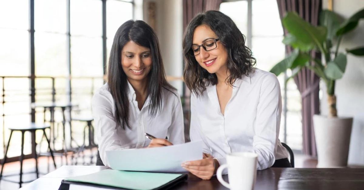 Startup founders signing company registration documents during business consultation
