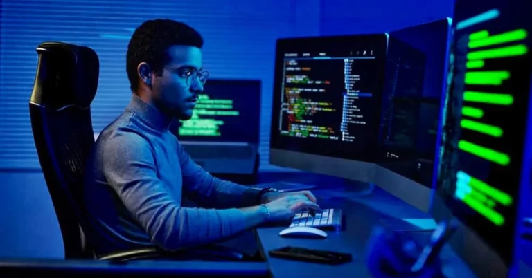 Indian developer staring at a computer screen as AI replaces developers thinking and coding tasks