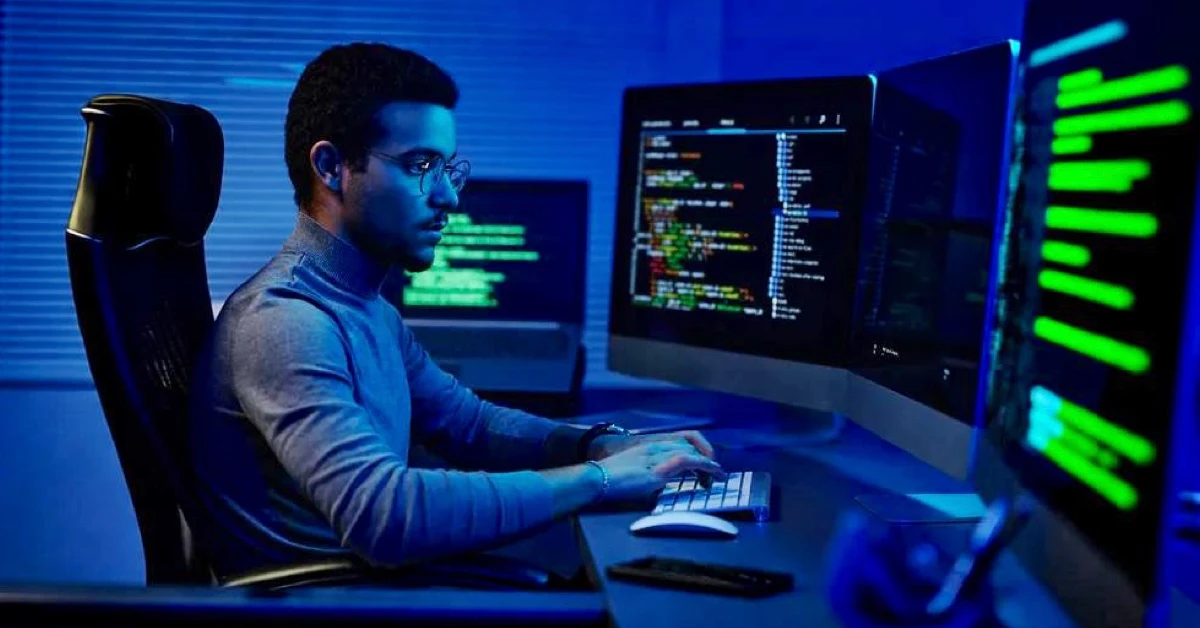 Indian developer staring at a computer screen as AI replaces developers thinking and coding tasks