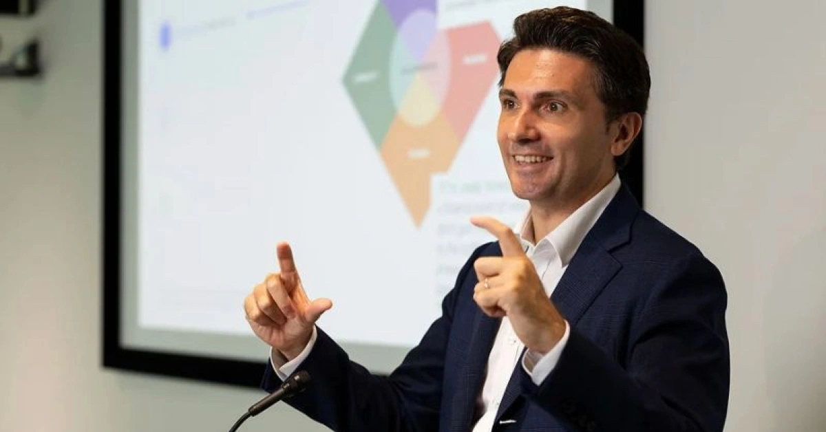 Roberto Croci speaking at a conference, discussing startup culture and work-life balance, captured from his X (Twitter) profile.