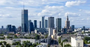 Skyline of Warsaw with modern skyscrapers representing Poland’s growing startup ecosystem and business incubators supporting IT freelancers.