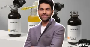Minimalist co-founder Mohit Yadav photographed with Minimalist skincare products in the background