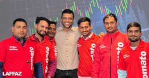 Zomato co-founder and Vice Chairman Deepinder Goyal stands with Zomato delivery partners, with a share price graph in the background