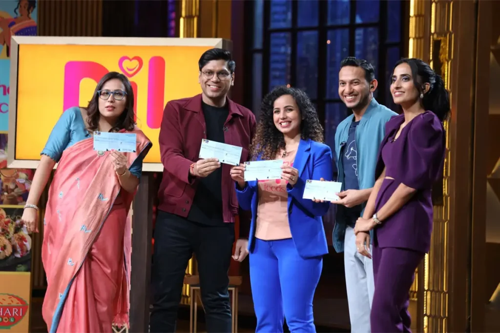 Dil Foods founder Arpita Aditi with Shark Tank India Season 3 investors (L-R) Radhika Gupta, Peyush Bansal, Arpita Aditi, Ritesh Agarwal, and Vineeta Singh after closing a ₹2 crore deal for 2.67% equity