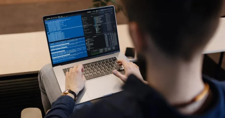 Fresher working on a laptop with machine learning code, building the skills needed for a first AI/ML job