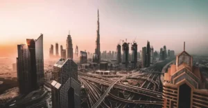 Dubai skyline at golden hour with the Burj Khalifa above a highway interchange, representing forex brokers regulated in the UAE